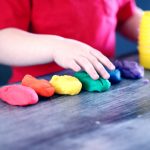 person making clay figures